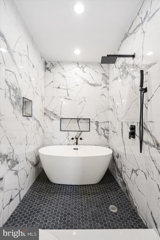 bathroom with tile patterned flooring and independent shower and bath