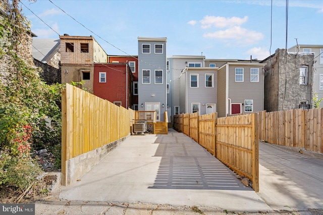 back of house featuring central AC