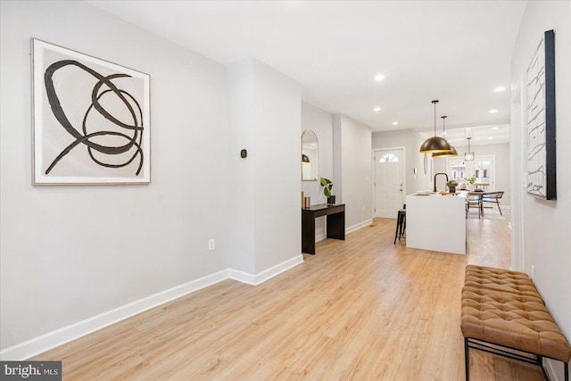 interior space with light hardwood / wood-style flooring and sink