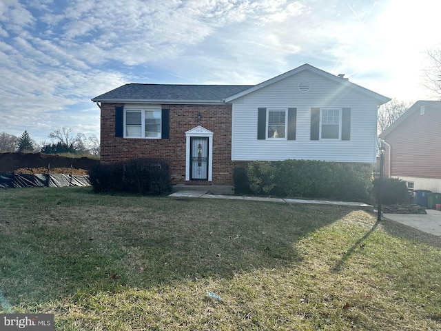 raised ranch with a front lawn