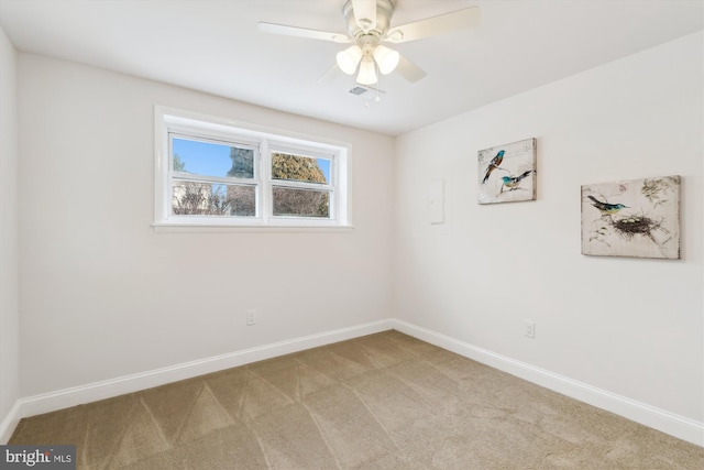 carpeted spare room featuring ceiling fan