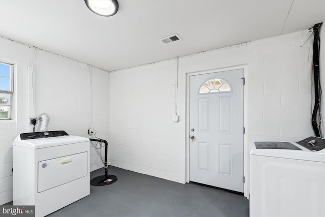 clothes washing area with separate washer and dryer