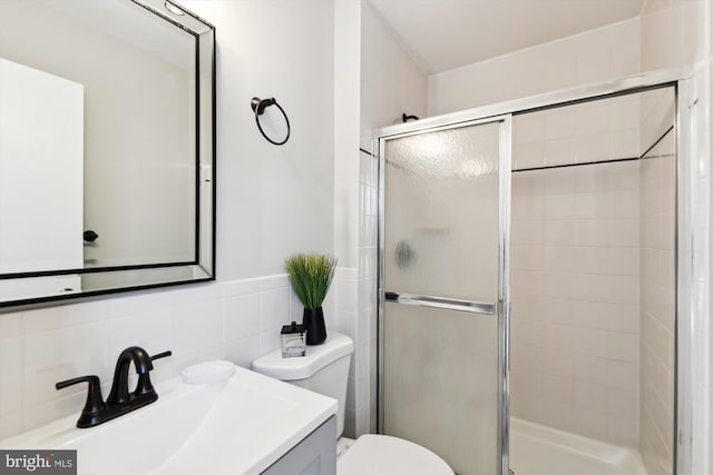 bathroom featuring toilet, decorative backsplash, walk in shower, and vanity