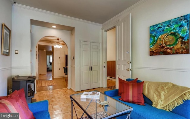 living room featuring crown molding, a baseboard radiator, and light parquet floors