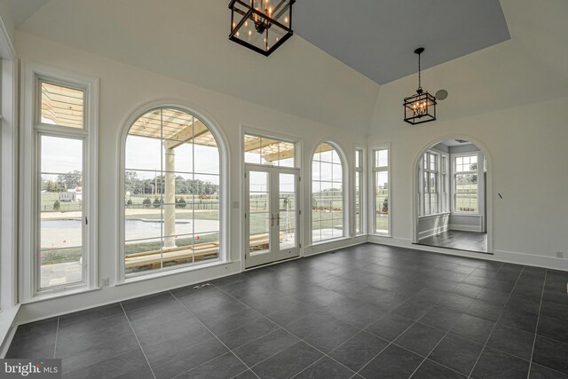 unfurnished sunroom with a notable chandelier