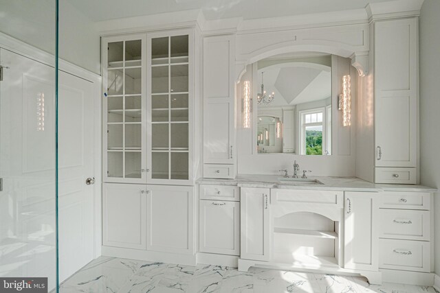 bathroom featuring vanity and a chandelier