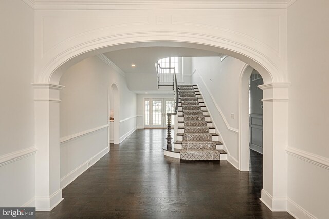 foyer with ornate columns, crown molding, and french doors