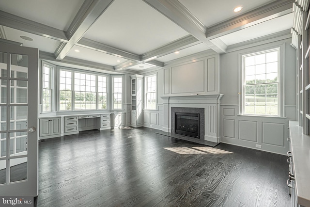 unfurnished living room with plenty of natural light, beam ceiling, a high end fireplace, and coffered ceiling