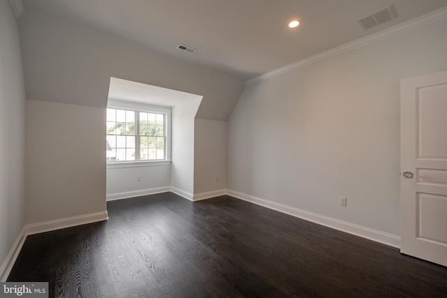 additional living space with dark hardwood / wood-style floors and lofted ceiling