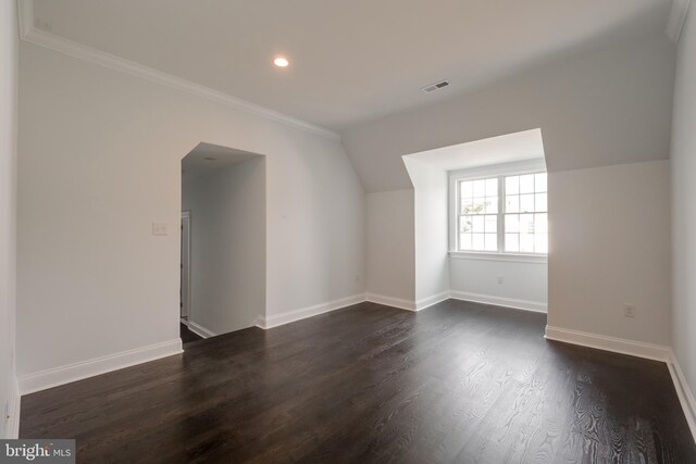 bonus room with dark hardwood / wood-style floors and vaulted ceiling