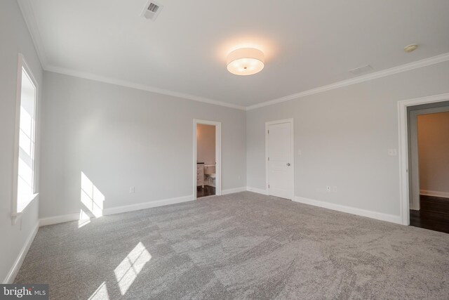 carpeted empty room featuring ornamental molding