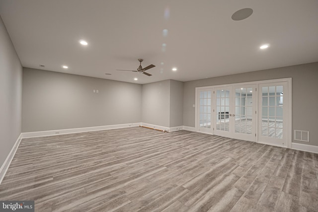 spare room with french doors, light wood-type flooring, and ceiling fan