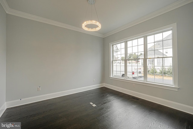 empty room featuring an inviting chandelier, plenty of natural light, and ornamental molding