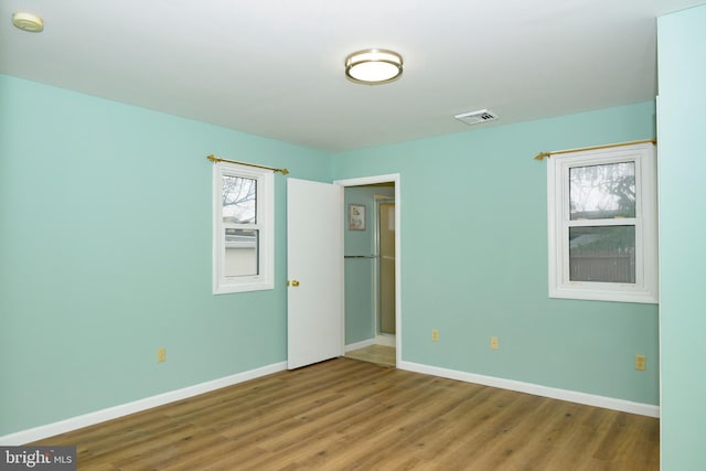 spare room with wood-type flooring