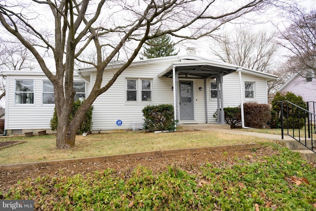 bungalow-style home with a front yard