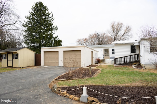 view of front facade with a front yard and a storage shed