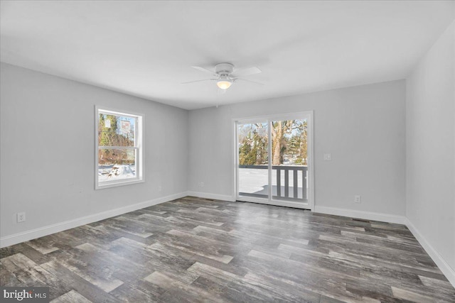 spare room with dark hardwood / wood-style floors and ceiling fan