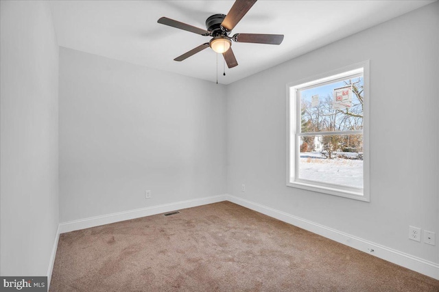 empty room with ceiling fan, carpet, and a healthy amount of sunlight