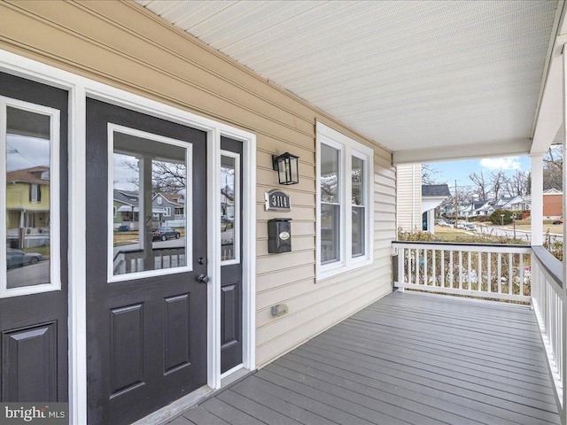 wooden terrace featuring covered porch