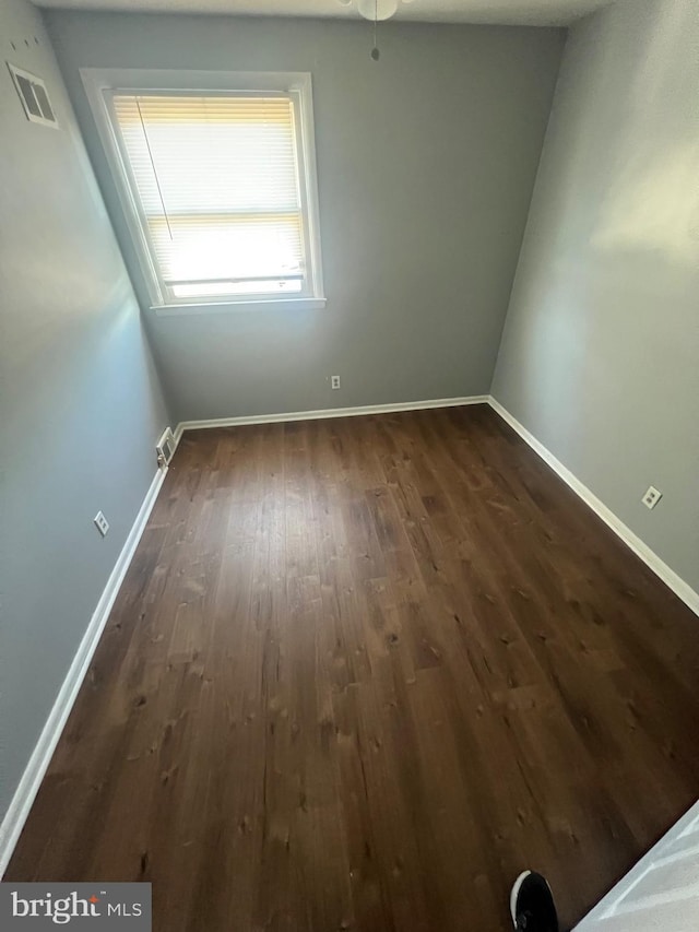 unfurnished room with dark hardwood / wood-style floors