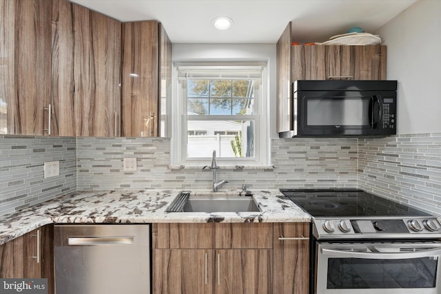 kitchen featuring appliances with stainless steel finishes, backsplash, and sink