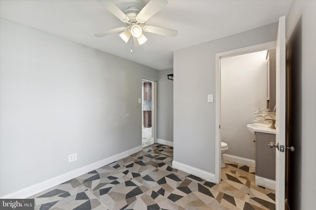 unfurnished bedroom featuring connected bathroom, ceiling fan, and sink