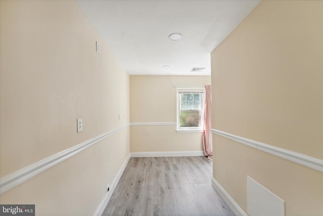 corridor with light hardwood / wood-style flooring