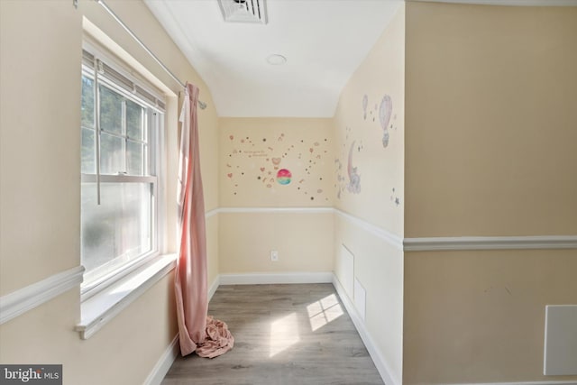 hallway with a wealth of natural light and light hardwood / wood-style floors