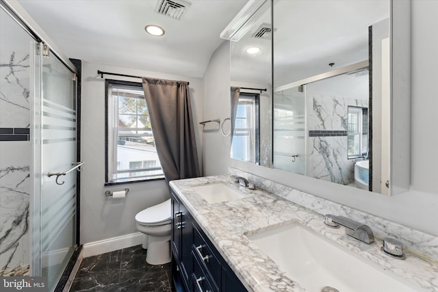 bathroom with vanity, toilet, and a shower with door