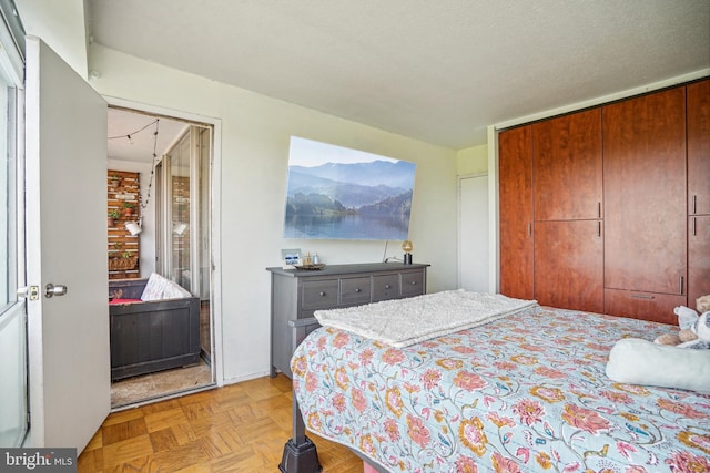 bedroom with light parquet floors and a closet