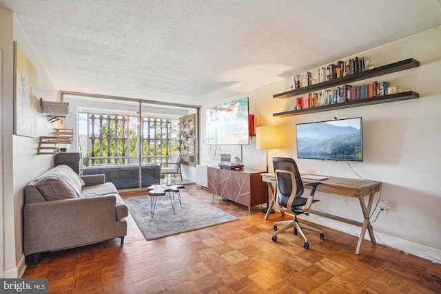 office space featuring parquet flooring and a textured ceiling