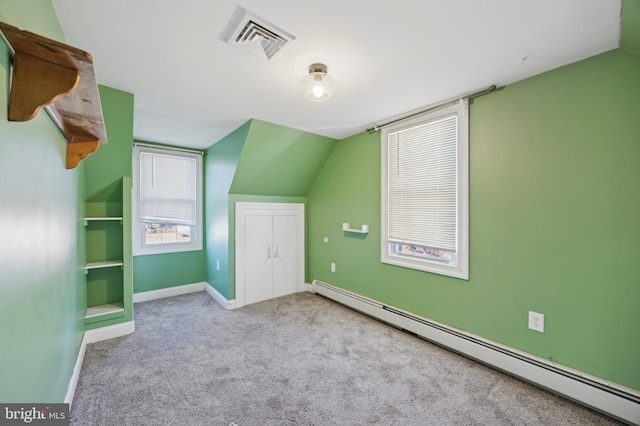 bonus room featuring light carpet, baseboard heating, and lofted ceiling