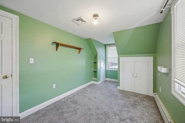 bonus room featuring baseboard heating and light carpet