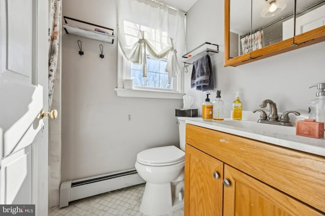 bathroom with vanity, toilet, walk in shower, and a baseboard radiator