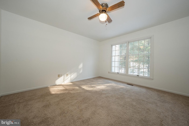 unfurnished room with ceiling fan and light colored carpet