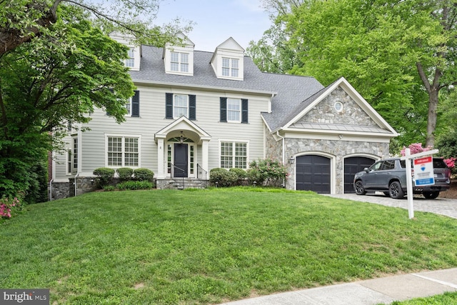 view of front of house with a garage and a front yard