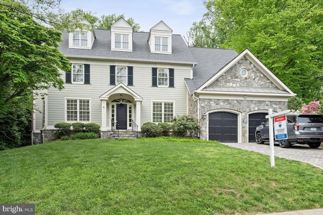 view of front of property with a garage and a front yard