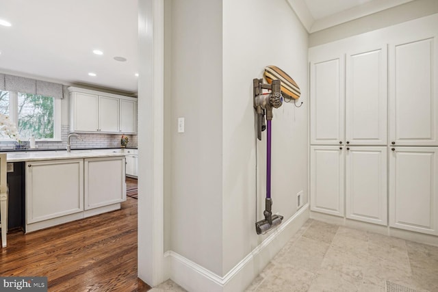 hall with sink and light hardwood / wood-style flooring