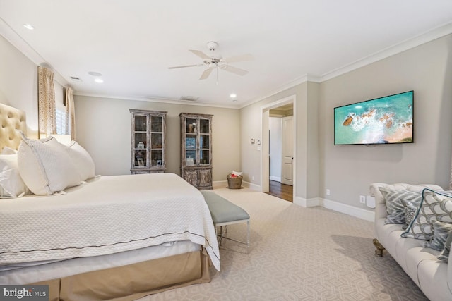 carpeted bedroom featuring ceiling fan and crown molding