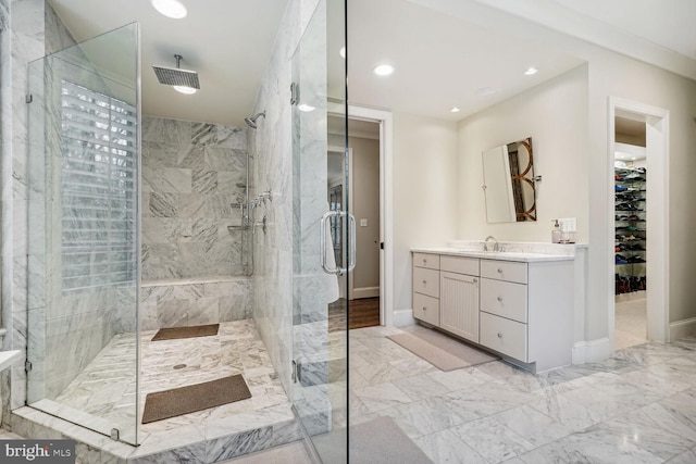 bathroom with a shower with door and vanity