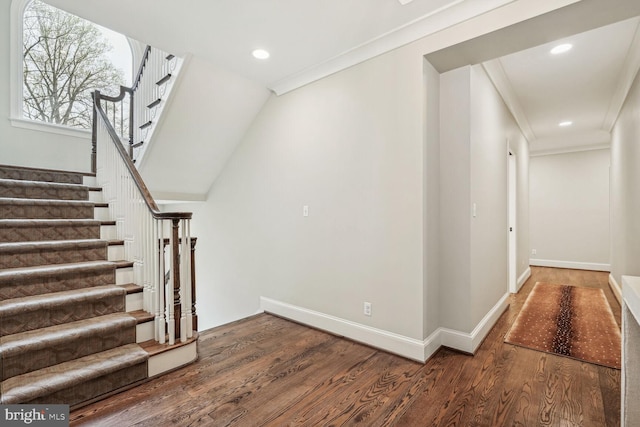 stairs featuring hardwood / wood-style flooring and ornamental molding