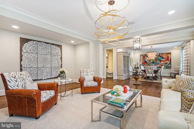 living room with hardwood / wood-style floors, crown molding, and a notable chandelier