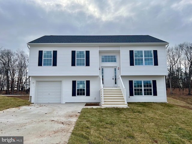 bi-level home featuring a front lawn and a garage