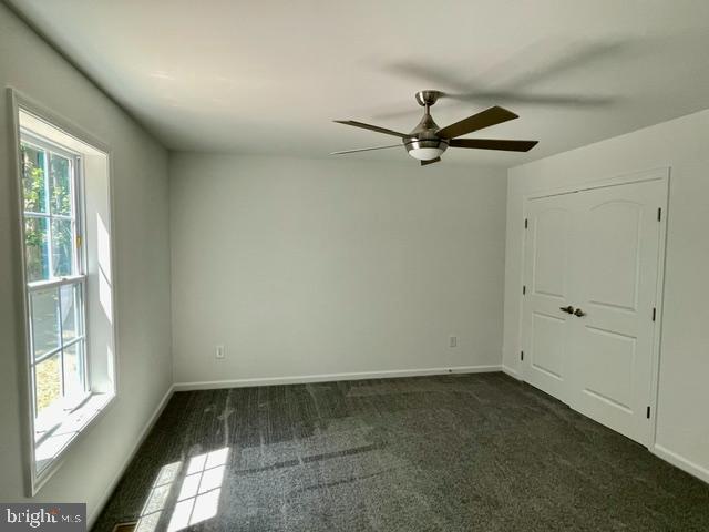 carpeted empty room with ceiling fan