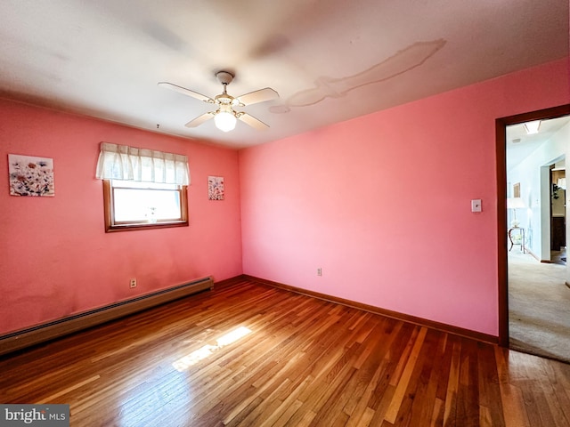 unfurnished room with a baseboard radiator, wood finished floors, a ceiling fan, and baseboards