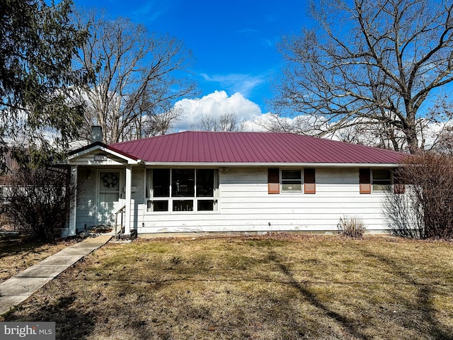 single story home with metal roof and a front yard