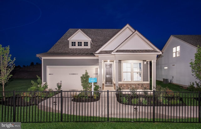 view of front of house with a porch, central AC, and a garage