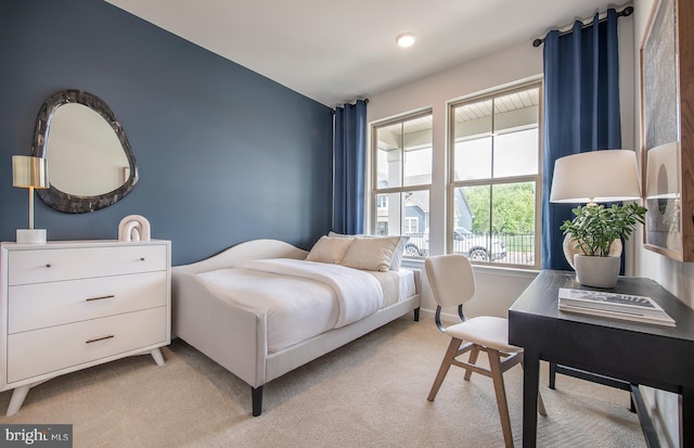 bedroom featuring light colored carpet