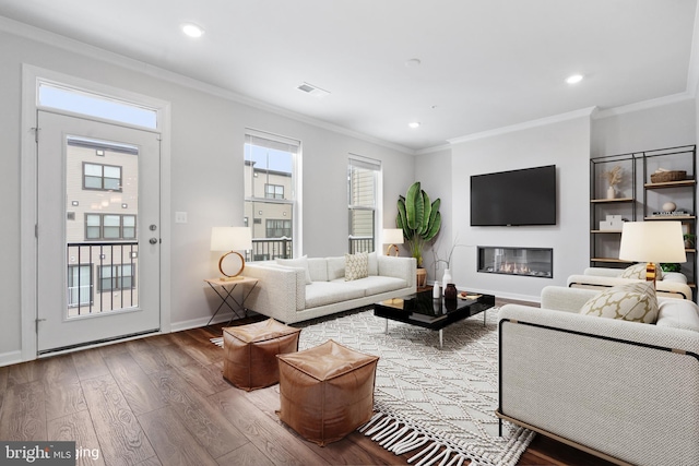 living room with wood-type flooring and ornamental molding