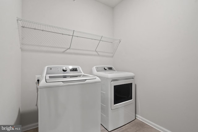 washroom with washer and dryer and light tile patterned flooring